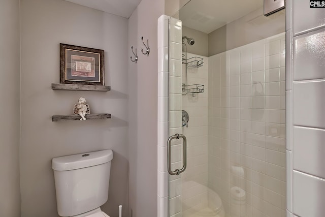 bathroom featuring toilet and walk in shower