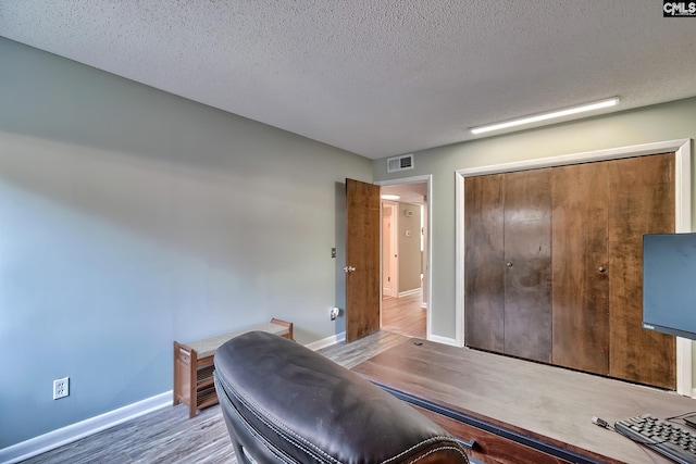 office area featuring hardwood / wood-style floors and a textured ceiling