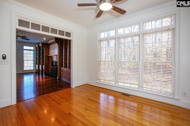 unfurnished room featuring crown molding, ceiling fan, and hardwood / wood-style flooring