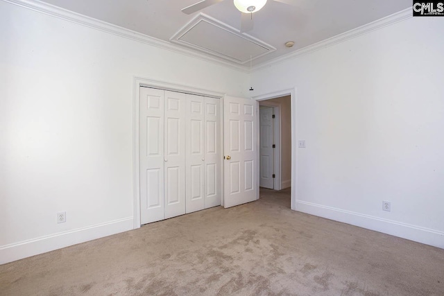 unfurnished bedroom featuring ceiling fan, ornamental molding, light carpet, and a closet