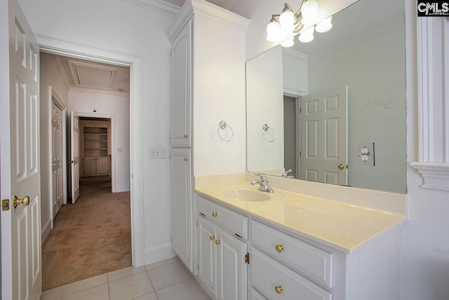 bathroom featuring tile patterned flooring, vanity, crown molding, and an inviting chandelier