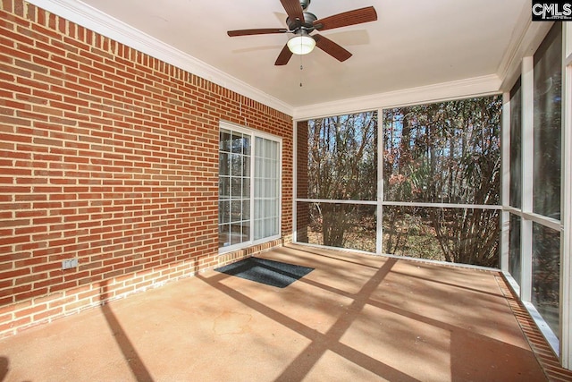 unfurnished sunroom featuring ceiling fan