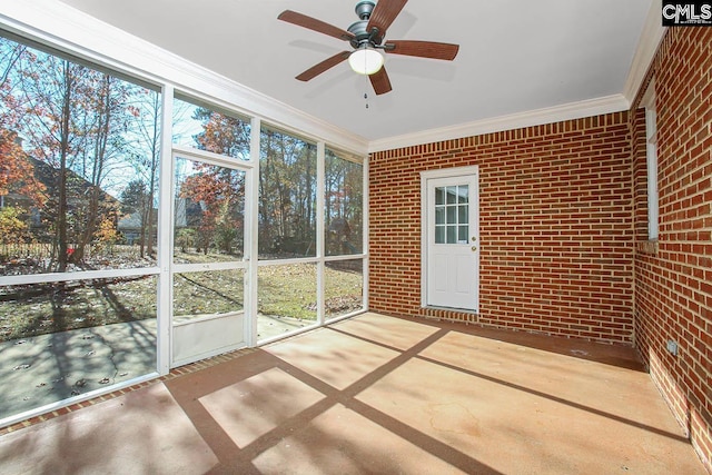 unfurnished sunroom with ceiling fan