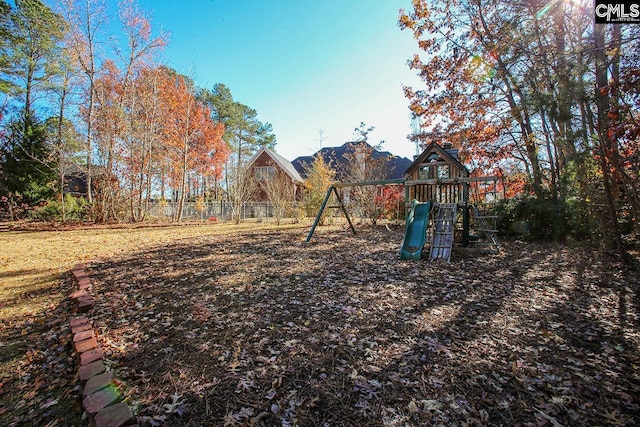 view of yard with a mountain view and a playground