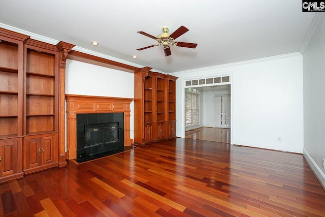 unfurnished living room with ceiling fan, dark hardwood / wood-style flooring, ornamental molding, and a tile fireplace