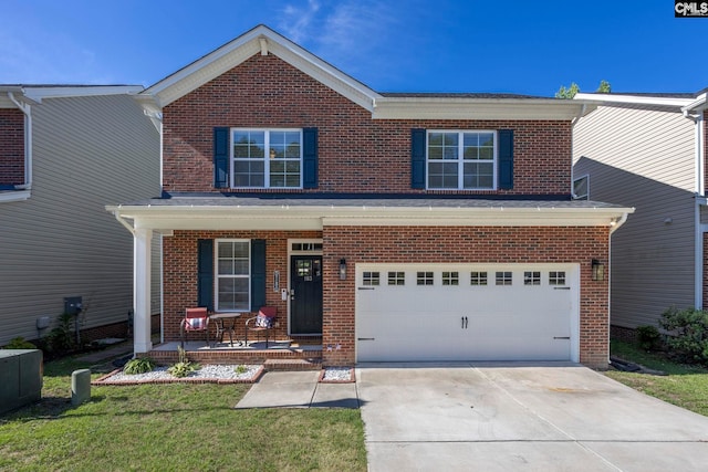 view of front property featuring a garage, a front yard, and covered porch