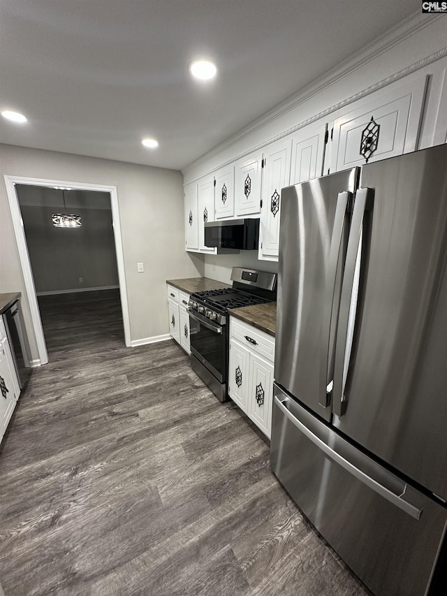 kitchen featuring appliances with stainless steel finishes, dark hardwood / wood-style floors, and white cabinets