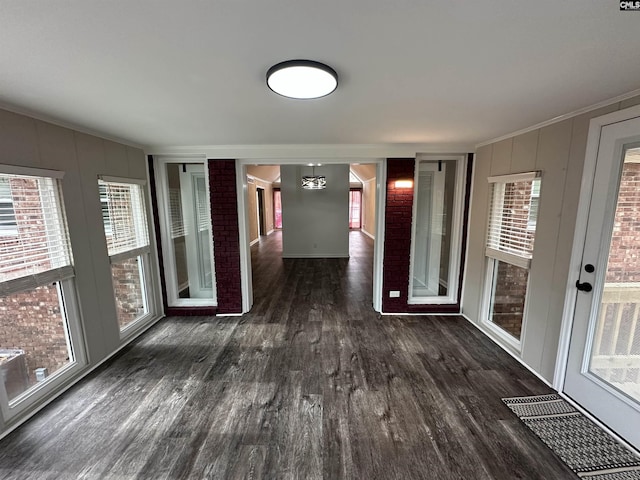 interior space with crown molding and dark hardwood / wood-style floors