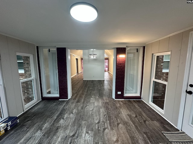 corridor with crown molding and dark wood-type flooring