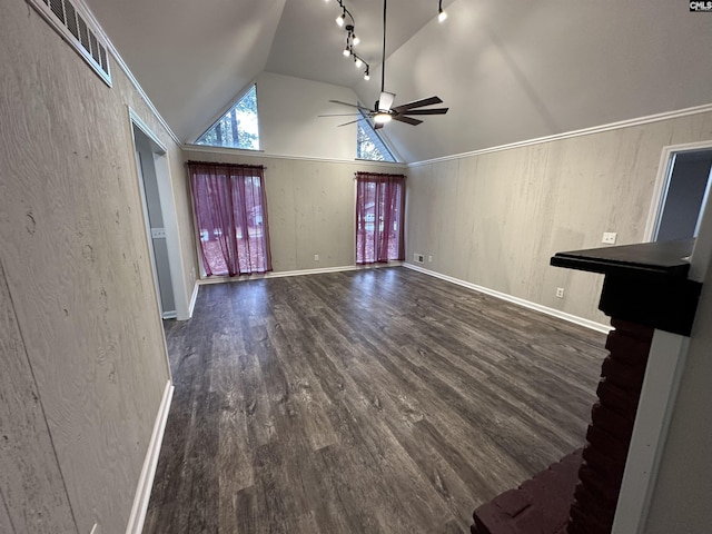 unfurnished living room featuring vaulted ceiling, dark hardwood / wood-style floors, ceiling fan, and track lighting