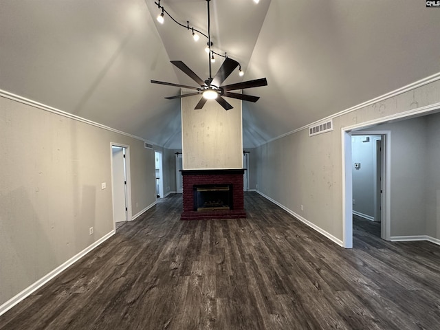 unfurnished living room with ceiling fan, a brick fireplace, dark hardwood / wood-style floors, track lighting, and vaulted ceiling