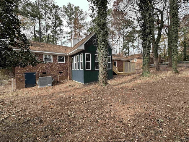 view of side of home featuring cooling unit