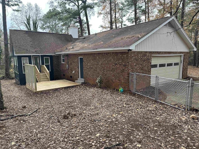 rear view of house featuring a garage