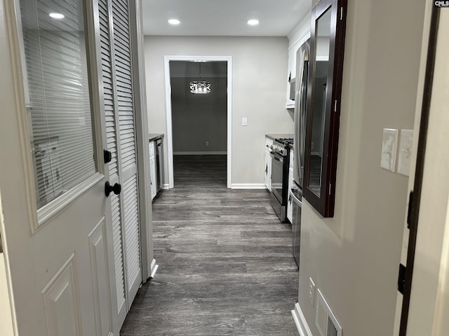 corridor with dark wood-type flooring