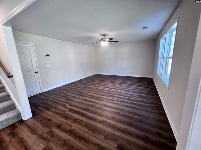 spare room with ceiling fan and dark hardwood / wood-style floors