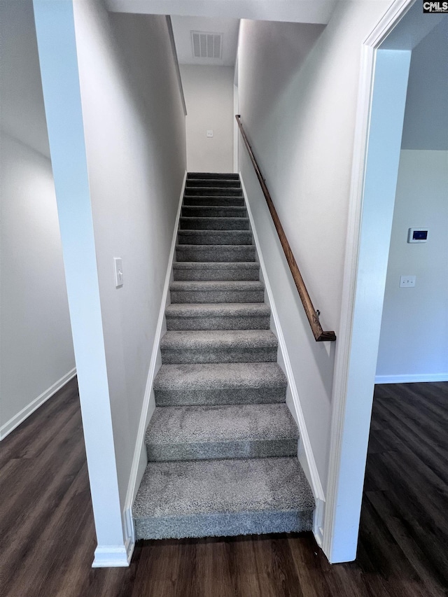 stairway featuring wood-type flooring