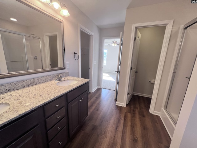 bathroom with ceiling fan, hardwood / wood-style floors, vanity, and an enclosed shower