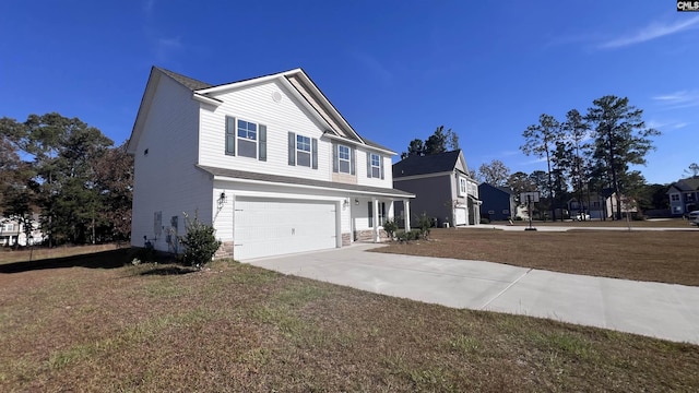 view of front property featuring a garage and a front lawn