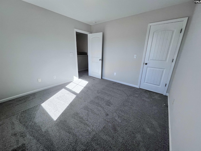 unfurnished bedroom featuring dark colored carpet