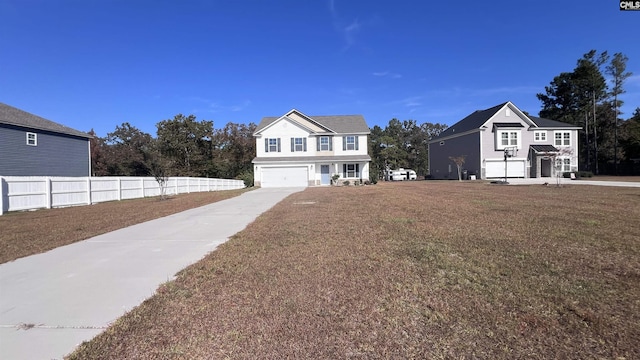 view of front of house featuring a garage and a front lawn