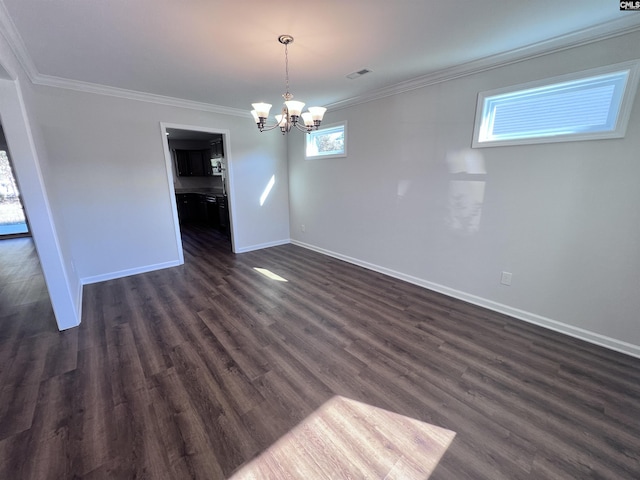 unfurnished dining area featuring dark hardwood / wood-style flooring, an inviting chandelier, and crown molding