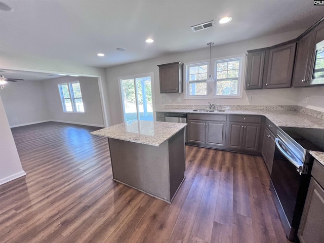 kitchen featuring ceiling fan, sink, a center island, dark hardwood / wood-style floors, and appliances with stainless steel finishes