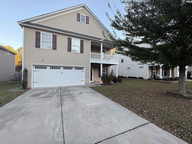 view of front of home with a balcony, a garage, a front lawn, and central air condition unit