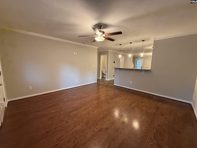 unfurnished living room featuring a textured ceiling, ceiling fan, dark hardwood / wood-style floors, and ornamental molding