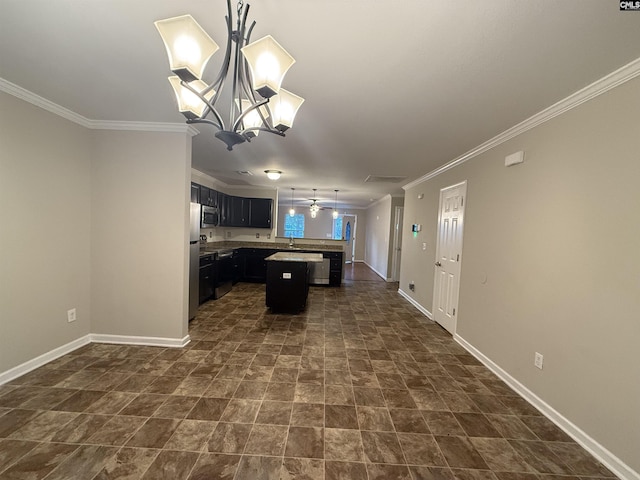 kitchen with a center island, sink, ornamental molding, stainless steel appliances, and a chandelier