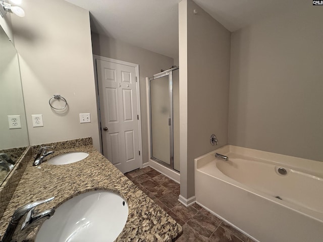 bathroom featuring vanity and independent shower and bath