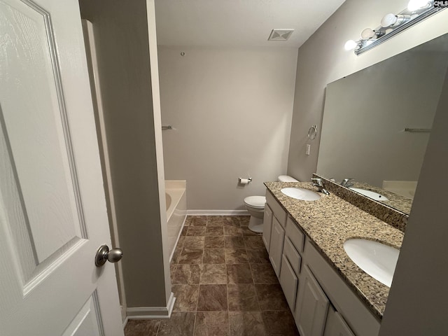 bathroom featuring a bath, vanity, and toilet