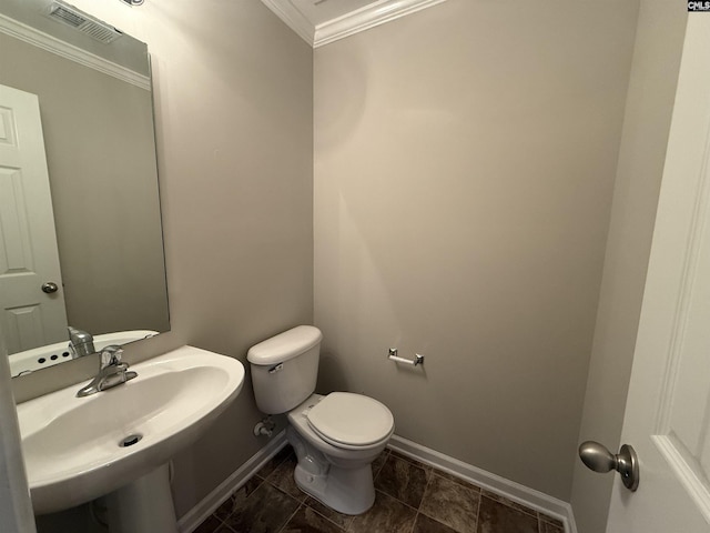 bathroom with sink, toilet, and crown molding