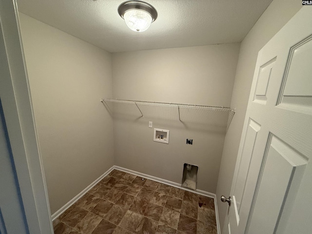 washroom featuring hookup for a washing machine, a textured ceiling, and electric dryer hookup