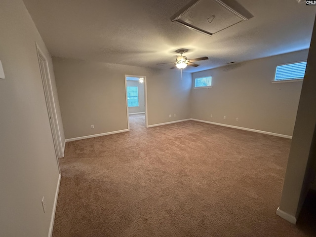 carpeted empty room with a textured ceiling and ceiling fan