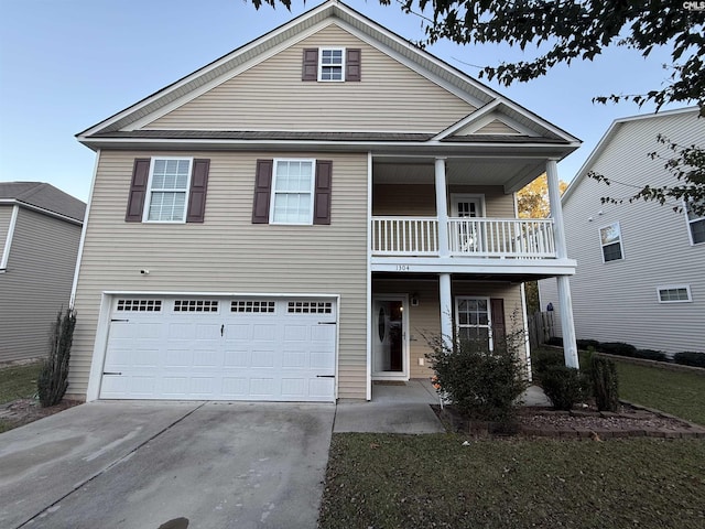 view of front facade featuring a balcony and a garage