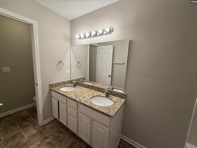 bathroom with vanity and toilet