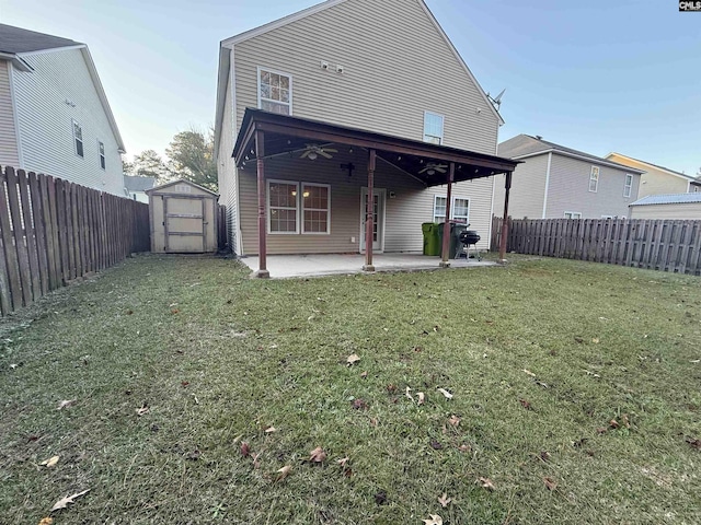 rear view of house featuring a yard, a patio, a shed, and ceiling fan