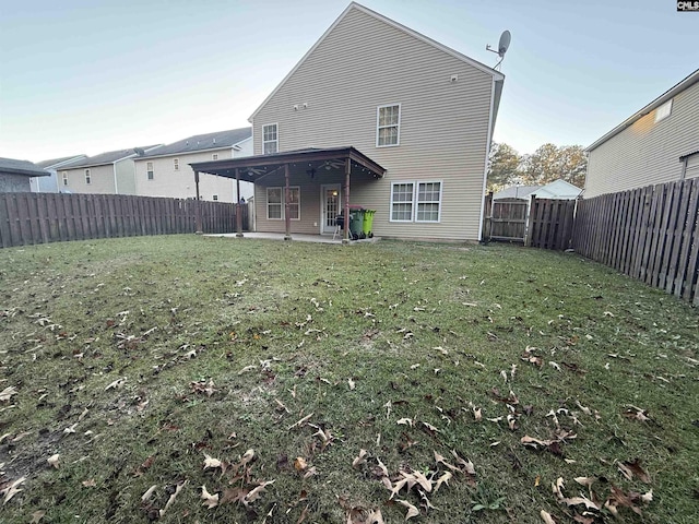 back of property featuring a lawn and a patio