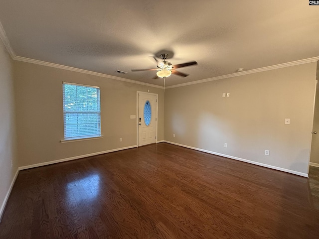 spare room featuring a textured ceiling, ceiling fan, crown molding, and dark wood-type flooring