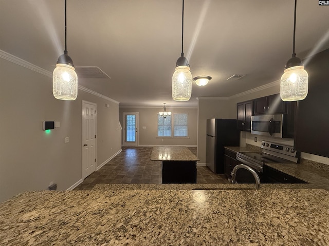 kitchen featuring a center island, sink, stainless steel appliances, pendant lighting, and ornamental molding