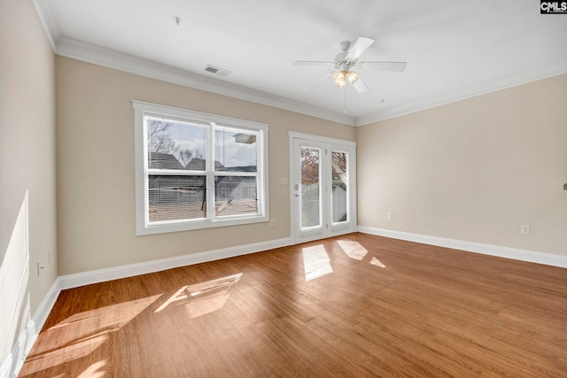 empty room with wood-type flooring, ceiling fan, and crown molding