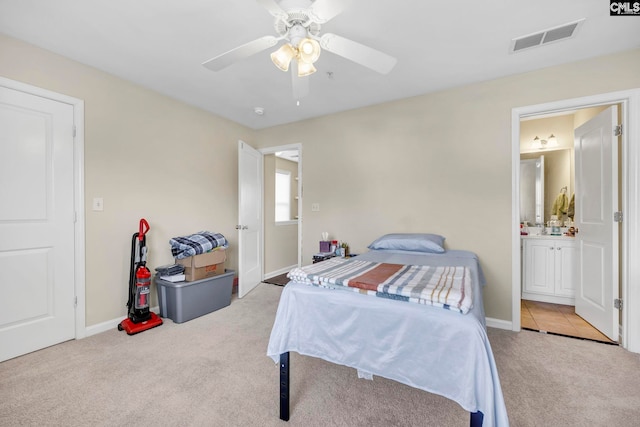 carpeted bedroom featuring ceiling fan and ensuite bathroom