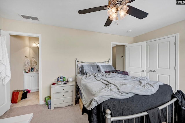 bedroom with ceiling fan, a closet, and light carpet