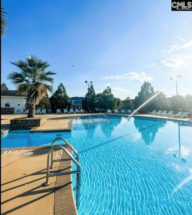 view of swimming pool featuring a patio area