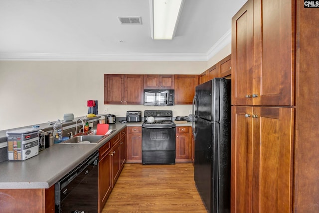 kitchen with sink, light hardwood / wood-style floors, crown molding, and black appliances