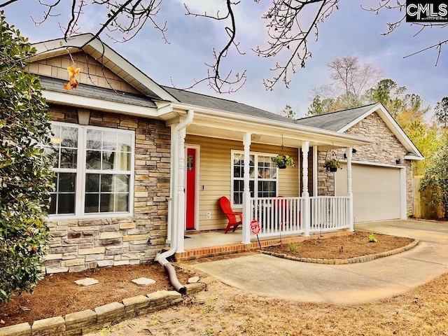 ranch-style house featuring a porch and a garage