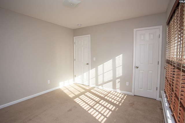 empty room featuring light colored carpet