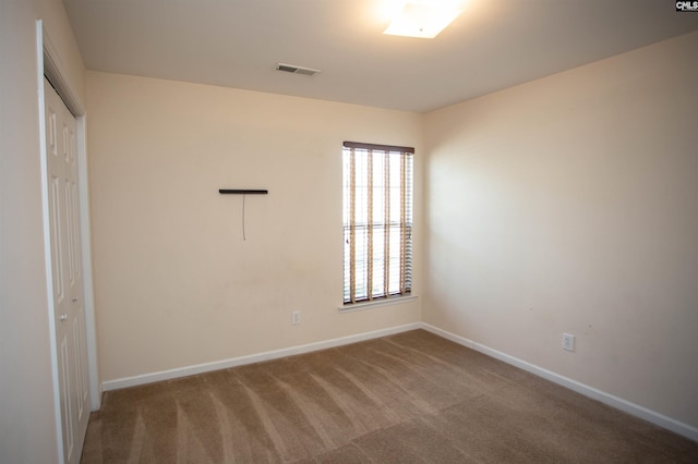 unfurnished bedroom featuring carpet flooring and a closet