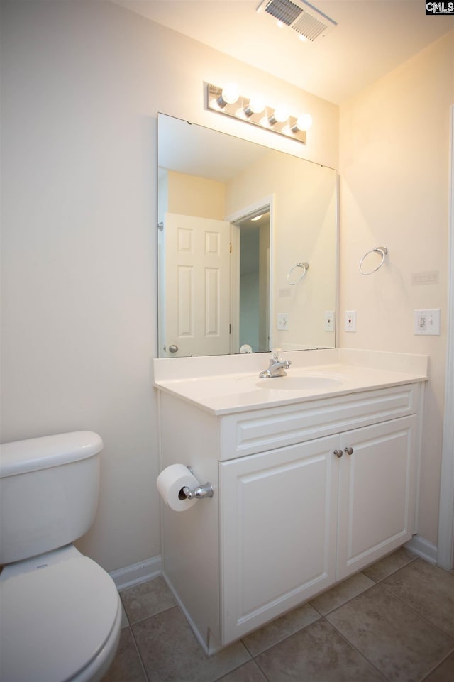 bathroom with tile patterned floors, vanity, and toilet