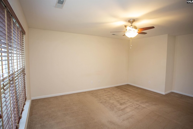 spare room with carpet floors and ceiling fan